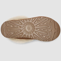 Close-up of a brown sole with a brand logo on a light gray background