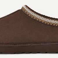 Brown slipper with patterned trim on a white background