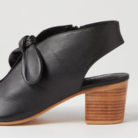 Black leather shoe with wooden heel on a white background