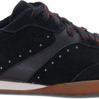 A black suede and synthetic fabric low-top sneaker with red laces, a white heel tab, and a brown gum sole, shown from a side profile on a white background.