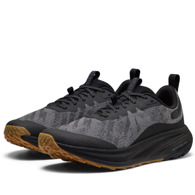 Black and gray athletic shoes with brown soles on a white background