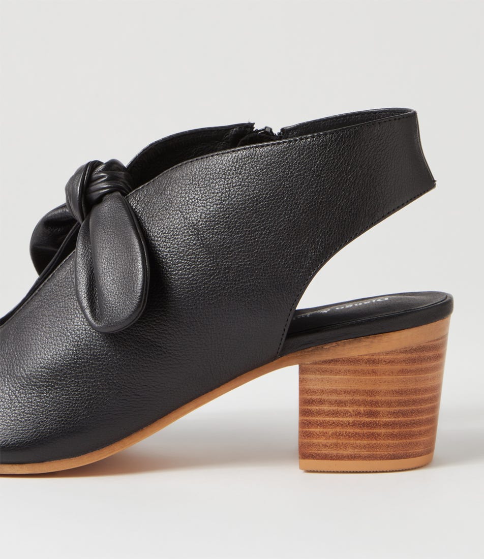 Black leather shoe with wooden heel on a white background