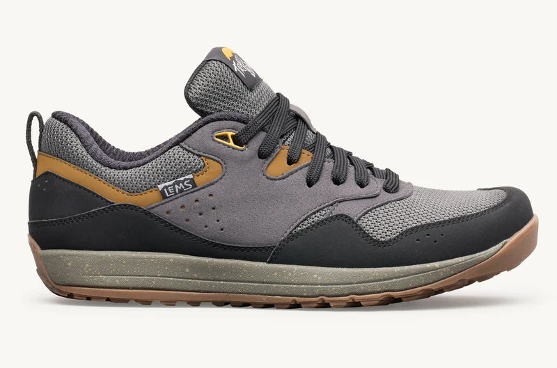 Gray and black sneaker with brown accents on a white background