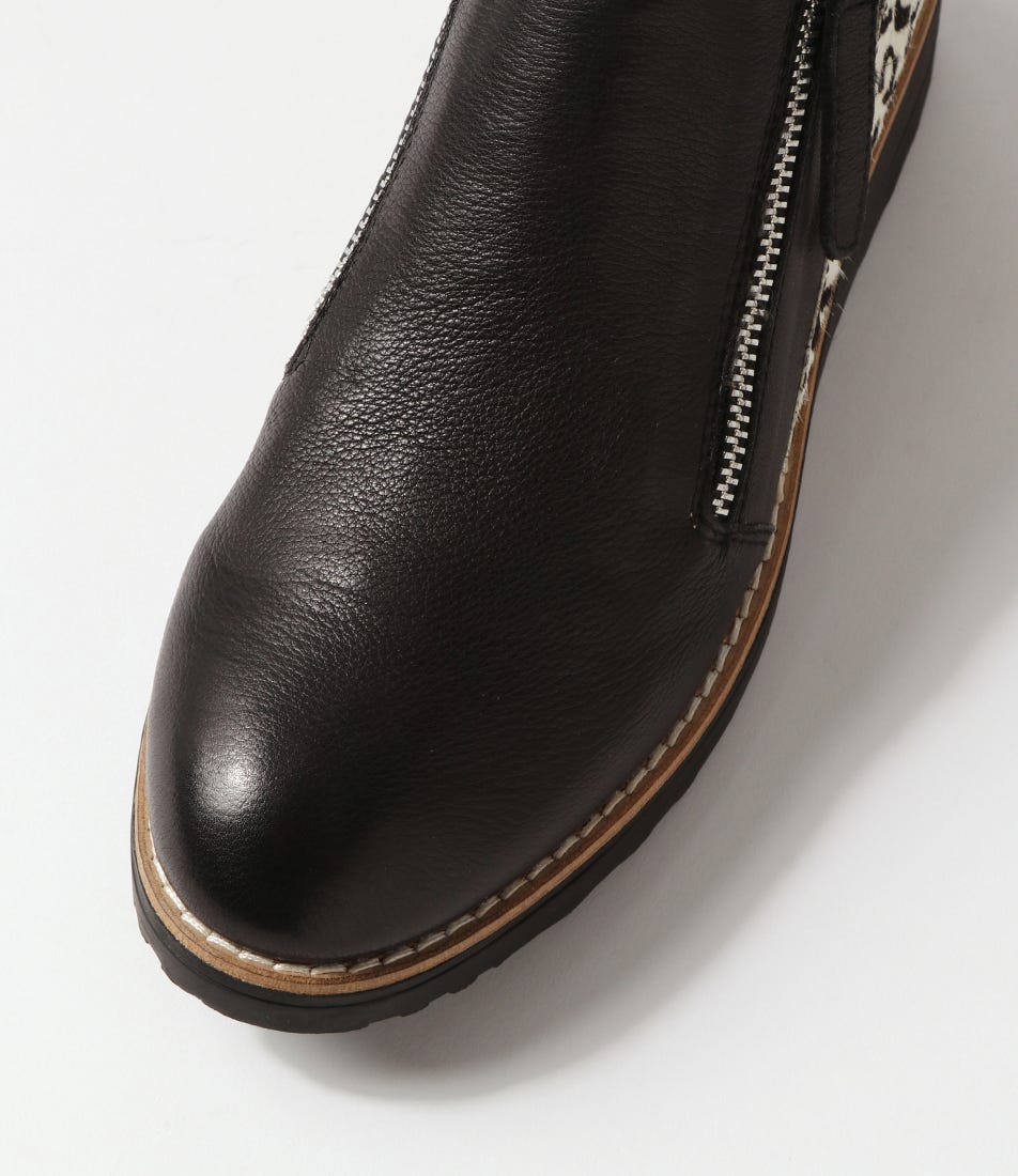 Black leather boot with a zipper on a white background