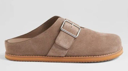Brown suede clog shoe with a buckle on a light gray background