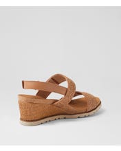 Ziera Kift wedge sandal in coffee-toned raffia with adjustable straps, cushioned footbed, and mid-height wedge sole on a white background